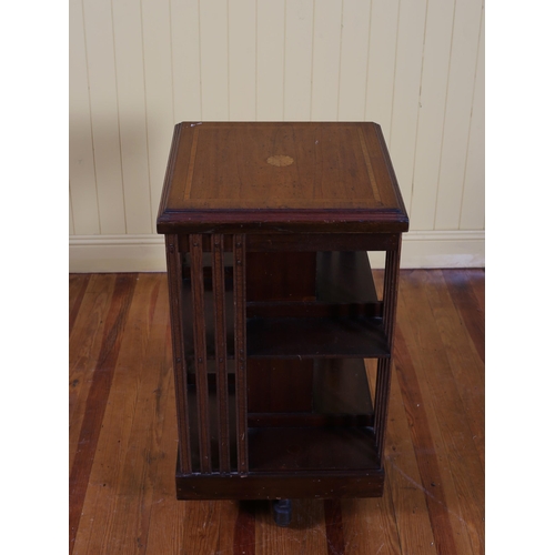 82 - AN EDWARDIAN MAHOGANY AND SATINWOOD INLAID REVOLVING BOOKSTAND the square moulded top above open com... 