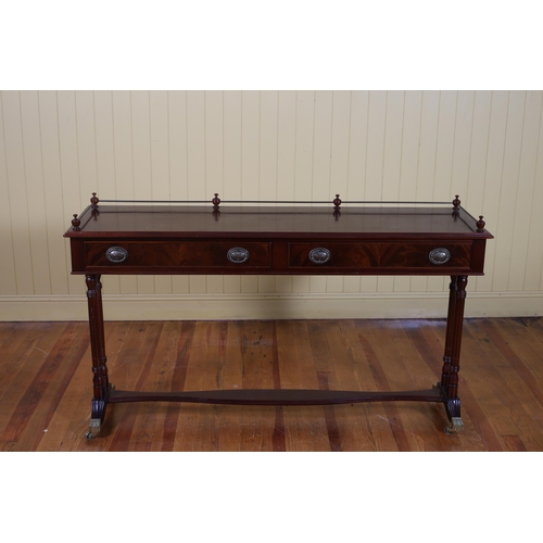 85 - A MAHOGANY CONSOLE TABLE the rectangular top with brass gallery above two frieze drawers on duel ree... 