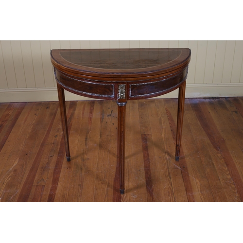 86 - A CONTINENTAL KINGWOOD WALNUT AND GILT BRASS MOUNTED FOLDOVER CARD TABLE of demi lune outline on ree... 