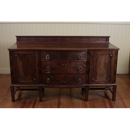 89 - A HEPPLEWHITE STYLE MAHOGANY SIDEBOARD of rectangular bowed outline the shaped top above three long ... 