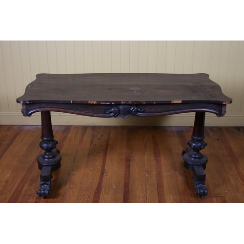 9 - A 19TH CENTURY ROSEWOOD CENTRE TABLE of serpentine outline the shaped top above a scroll frieze on b... 