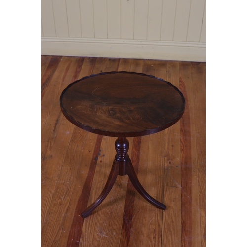 93 - A MAHOGANY TRAY TOP WINE TABLE of oval outline with pie crust rim above a baluster column on tripod ... 