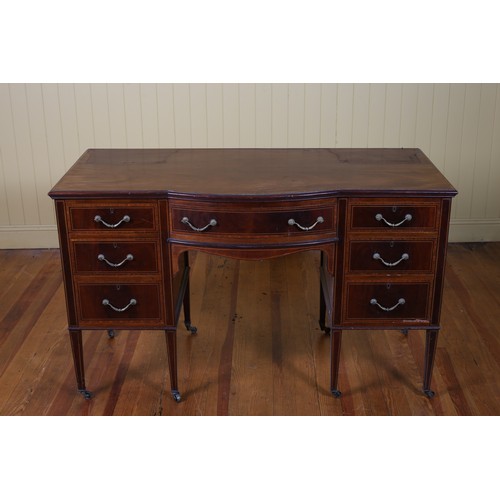 548 - AN EDWARDIAN MAHOGANY AND SATINWOOD INLAID DESK of rectangular bowed outline the shaped top above a ... 