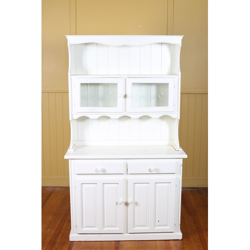 557 - A PINE WHITE PAINTED OPEN FRONT DRESSER the moulded cornice above an open shelf with glazed cupboard... 