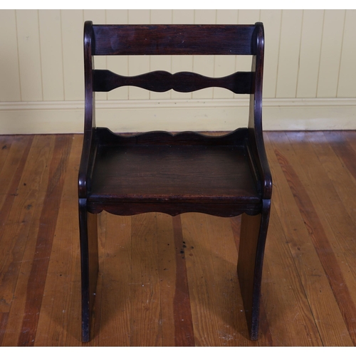 337 - A VINTAGE OAK SEAT the moulded top rail above a shaped splat with panel seat on standard end support... 