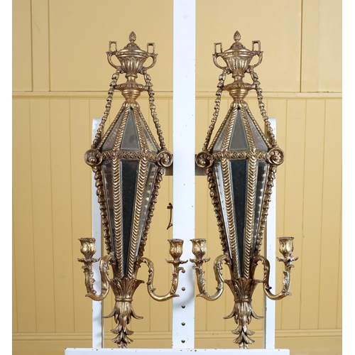 288 - A PAIR OF CONTINENTAL GILTWOOD AND MIRRORED TWO BRANCH WALL SCONCES each with a mirrored shaped back... 