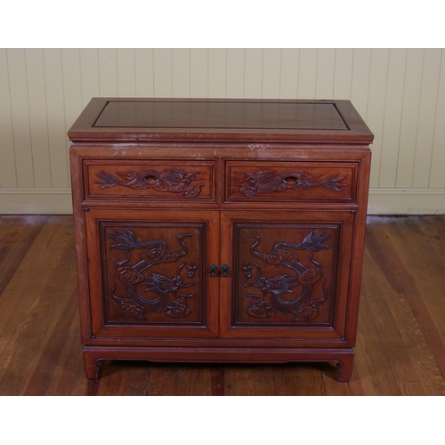 678 - A CHINESE CARVED ROSEWOOD SIDE CABINET of rectangular outline with frieze drawers and cupboards on m... 