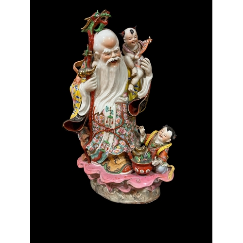 113 - A FAMILLE ROSE CHINA GROUP modelled as God of Longevity 67cm (h) x 41cm (w)