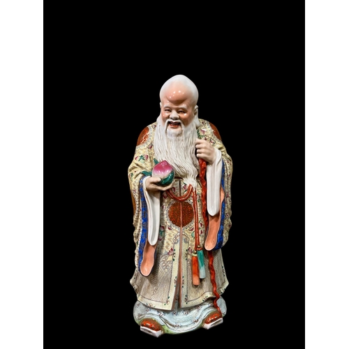 116 - A CHINESE FAMILLE ROSE CHINA FIGURE modelled as a male depicting longevity and wisdom 60cm (h)