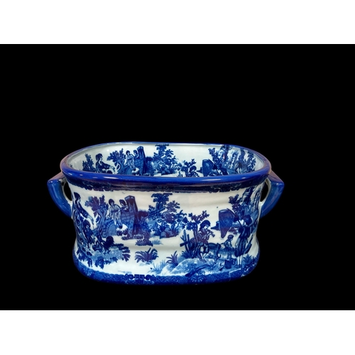 120 - A BLUE AND WHITE GLAZED CHINA FOOT BATH of oval outline decorated with figures in a landscape with p... 