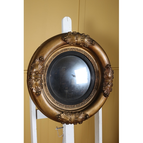 149 - A 19TH CENTURY GILTWOOD AND GESSO CONVEX MIRROR the molded frame decorated with stylised foliage 59c... 