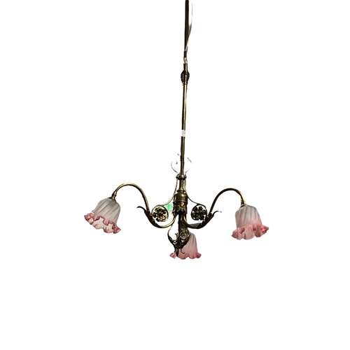 161 - A BRASS THREE BRANCH CENTRE LIGHT with foliate scroll arms with frosted glass shades 110cm drop