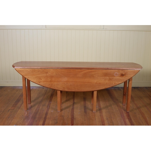 173 - A GEORGIAN STYLE MAHOGANY DROP LEAF HUNT TABLE the oval hinged top on square moulded legs87cm (h) x ... 