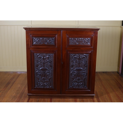 180 - A VINTAGE CARVED MAHOGANY SIDE CABINET of rectangular outline the shaped top above a pair of cupboar... 