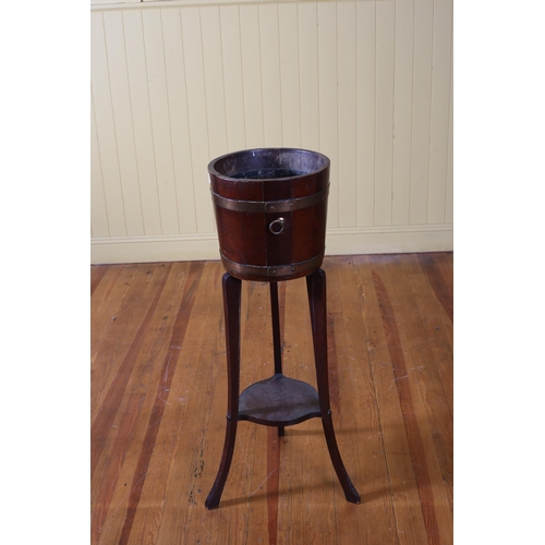 193 - A VINTAGE OAK AND BRASS BOUND JARDINIERE of cylindrical tapering form with brass ring handles on mou... 