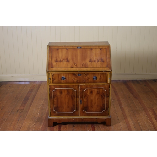 204 - A YEW WOOD BUREAU the hinged writing slope with tooled leather inset with pigeon holes and drawers a... 