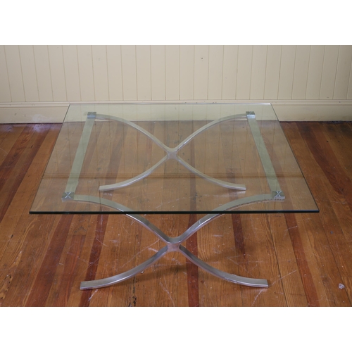 209 - A DESIGNER CHROME AND GLAZED COFFEE TABLE the rectangular glazed plate raised on X-shaped supports 4... 