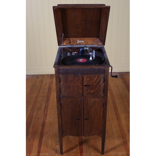 212 - A VINTAGE DULCETTO OAK CASED GRAMOPHONE on square moulded legs 100cm (h) x 46cm (w) x 53cm (d)  toge... 