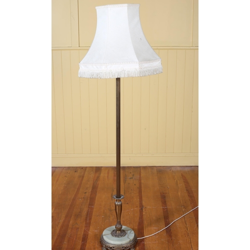 217 - A VINTAGE BRASS AND ONYX FLOOR STANDARD LAMP the reeded column above a circular spreading foot with ... 