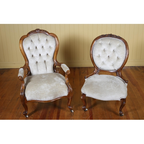 22 - A VICTORIAN CARVED MAHOGANY AND UPHOLSTERED LADY'S AND GENTLEMAN'S CHAIR each with a carved top rail... 