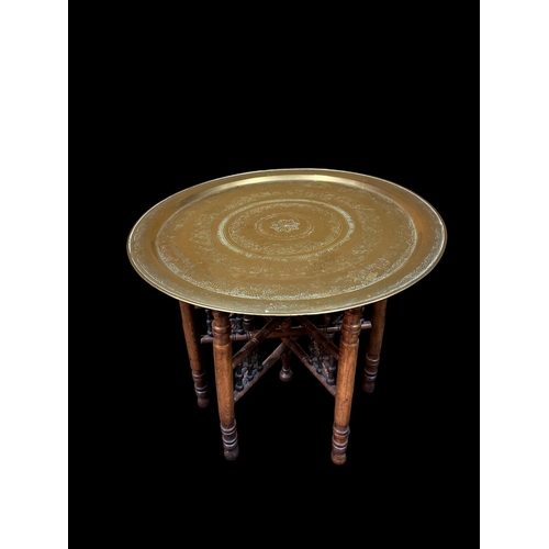 229 - A BRASS BENARES TRAY on folding stand 53cm (h) x 59cm (d)