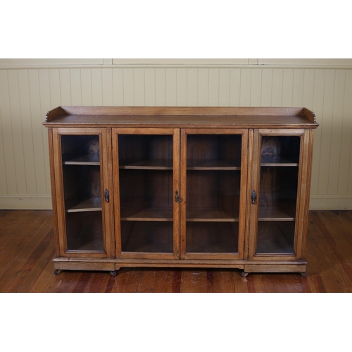 28 - A VINTAGE OAK SIDE CABINET of rectangular outline the shaped top above a moulded three quarter galle... 