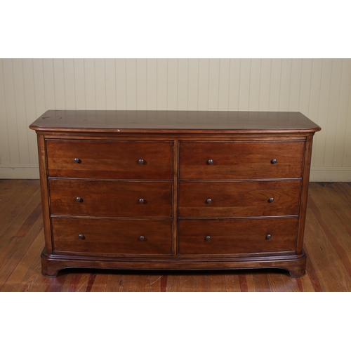 30 - A CHERRYWOOD LOWBOY of rectangular bowed outline the shaped top above six short drawers on shaped pl... 