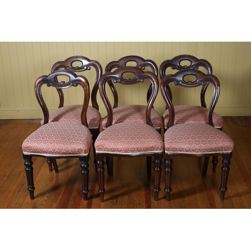 315 - A SET OF SIX VICTORIAN MAHOGANY DINING CHAIRS each with an arched pierced top rail with upholstered ... 