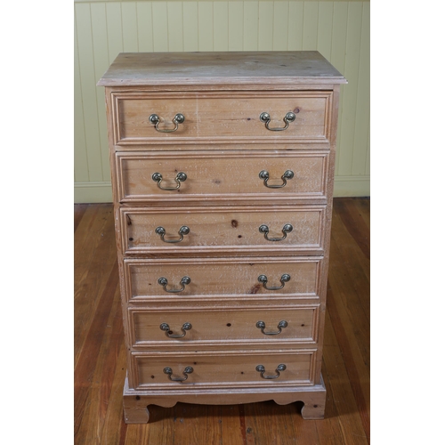 317 - A PINE TALLBOY of rectangular outline the shaped top above six long graduated drawers with brass dro... 