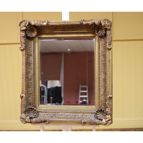 343 - A CONTINENTAL GILT FRAME MIRROR the rectangular bevelled glass plate within a foliate moulded frame ... 