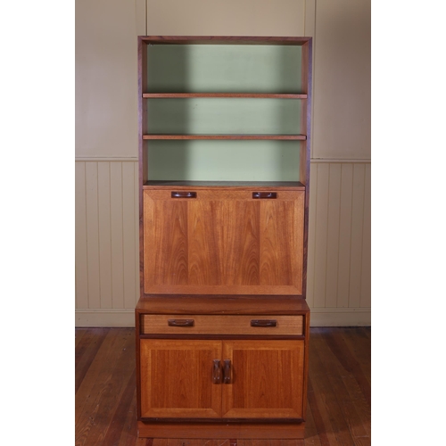 364 - A VINTAGE G-PLAN TEAK WALL CABINET / COCKTAIL CABINET of rectangular outline the shaped top above th... 