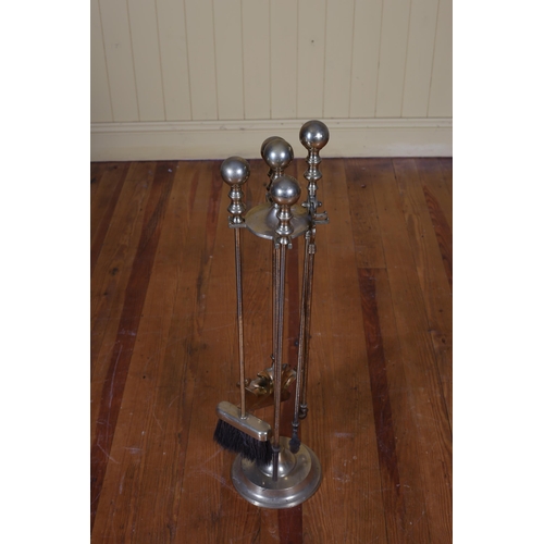 368 - A BRASS FOUR PIECE COMPANION SET ON STAND with spherical handles raised on a circular spreading foot