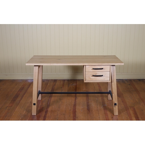 41 - A MODERN OAK DESK of rectangular outline the shaped top above two short drawers on square splayed le... 