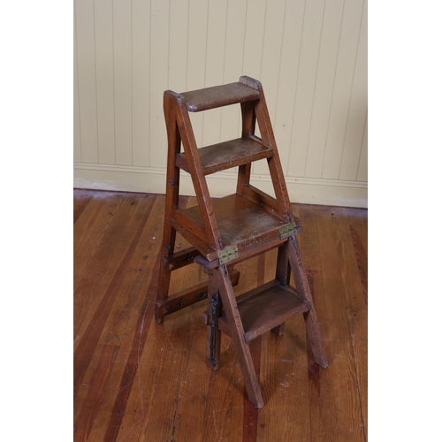 45 - AN ARTS AND CRAFTS OAK METAMORPHIC LIBRARY STEPS with pierced gothic tracery splats above a hinged s... 