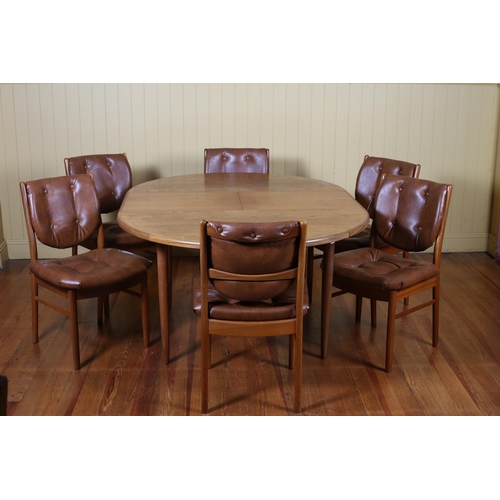 5 - A NINE PIECE VINTAGE TEAK DINING ROOM SUITE comprising eight chairs each with a buttoned upholstered... 