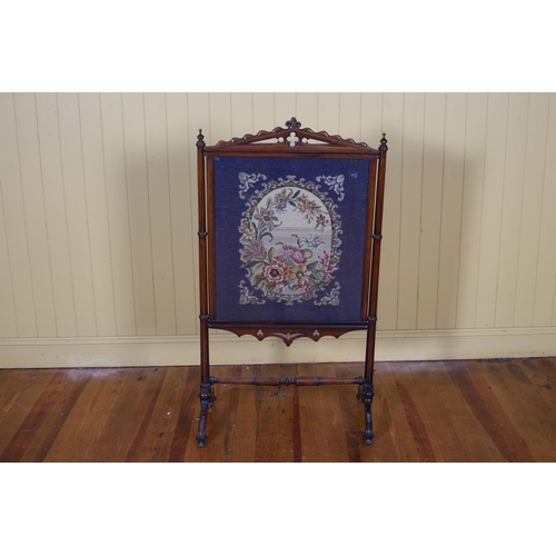 52 - A 19TH CENTURY MAHOGANY AND NEEDLEWORK FIRESCREEN the rectangular moulded frame with pierced crestin... 