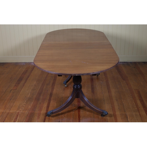 527 - A REGENCY STYLE MAHOGANY THREE POD DINING TABLE of rectangular outline with rounded ends and reeded ... 