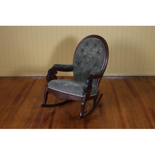 530 - A 19TH CENTURY MAHOGANY AND UPHOLSTERED ROCKING CHAIR the oval buttoned upholstered back and seat wi... 