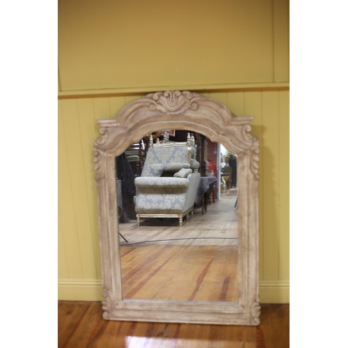 531 - A CONTINENTAL PAINTED FRAMED MIRROR the rectangular arched plate within a C-scroll and foliate frame... 