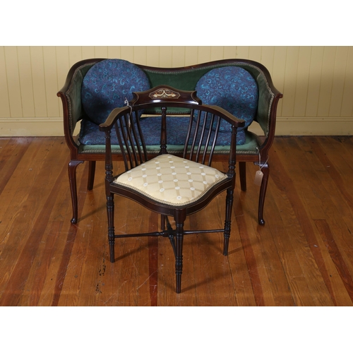 542 - AN EDWARDIAN MAHOGANY INLAID TWO SEATER SETTEE the serpentine top rail above an upholstered panel an... 