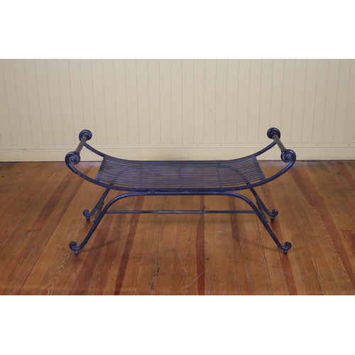 6 - A FORGED IRON BENCH with pierced slatted shaped seat and scroll arms on conforming legs 62cm (h) x 1... 