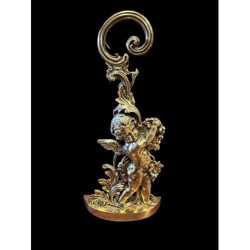 630 - A 19TH CENTURY BRASS FIGURAL DOOR STOP with pierced scroll handle on a demi lune platform 49cm (h) x... 