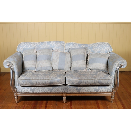 7 - A CONTINENTAL SILVERED AND UPHOLSTERED FOUR PIECE SUITE comprising a two seater settee with scroll o... 