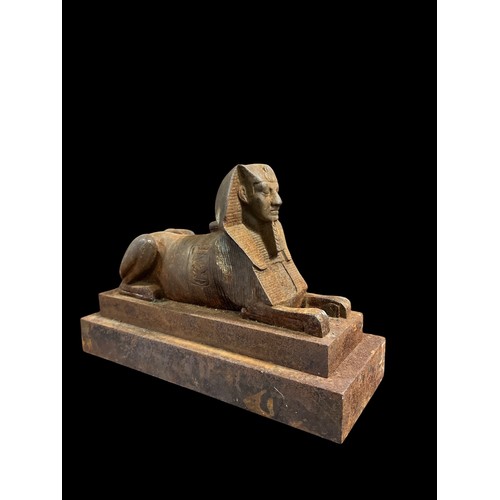 595 - A CAST IRON FIGURE modelled as sphinx raised on a rectangular platform 20cm (h) x 29cm (w) x 11cm (d... 