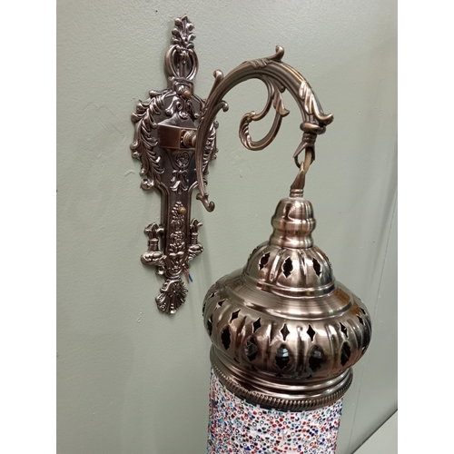 324 - A MOSAIC MOROCCAN STYLE WALL MOUNTED LIGHT with white metal pierced corona with C-scroll arm and fol... 