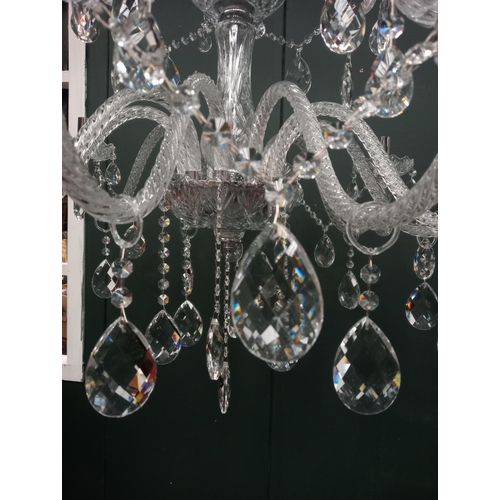 335 - A CONTINENTAL TWELVE BRANCH CUT GLASS CHANDELIER in two registers hung with faceted chains and penda... 