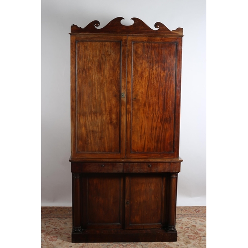 570 - A 19TH CENTURY MAHOGANY CUPBOARD the swan neck pediment above a pair of panel doors containing adjus... 