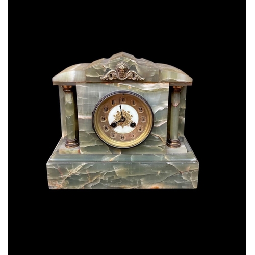 109 - A VINTAGE GREEN ONYX MANTEL CLOCK of architectural outline the circular gilt brass and bone dial fla... 