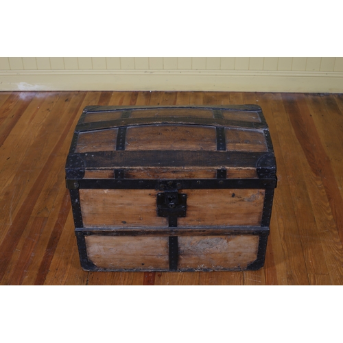 399 - A VINTAGE STAINED WOOD AND STEEL BOUND CABIN TRUNK of rectangular form the dome lid containing a rem... 