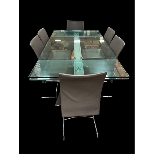 404 - A ROCHE BOBOIS SEVEN PIECE DINING ROOM SUITE comprising draw leaf glazed and chrome dining table on ... 